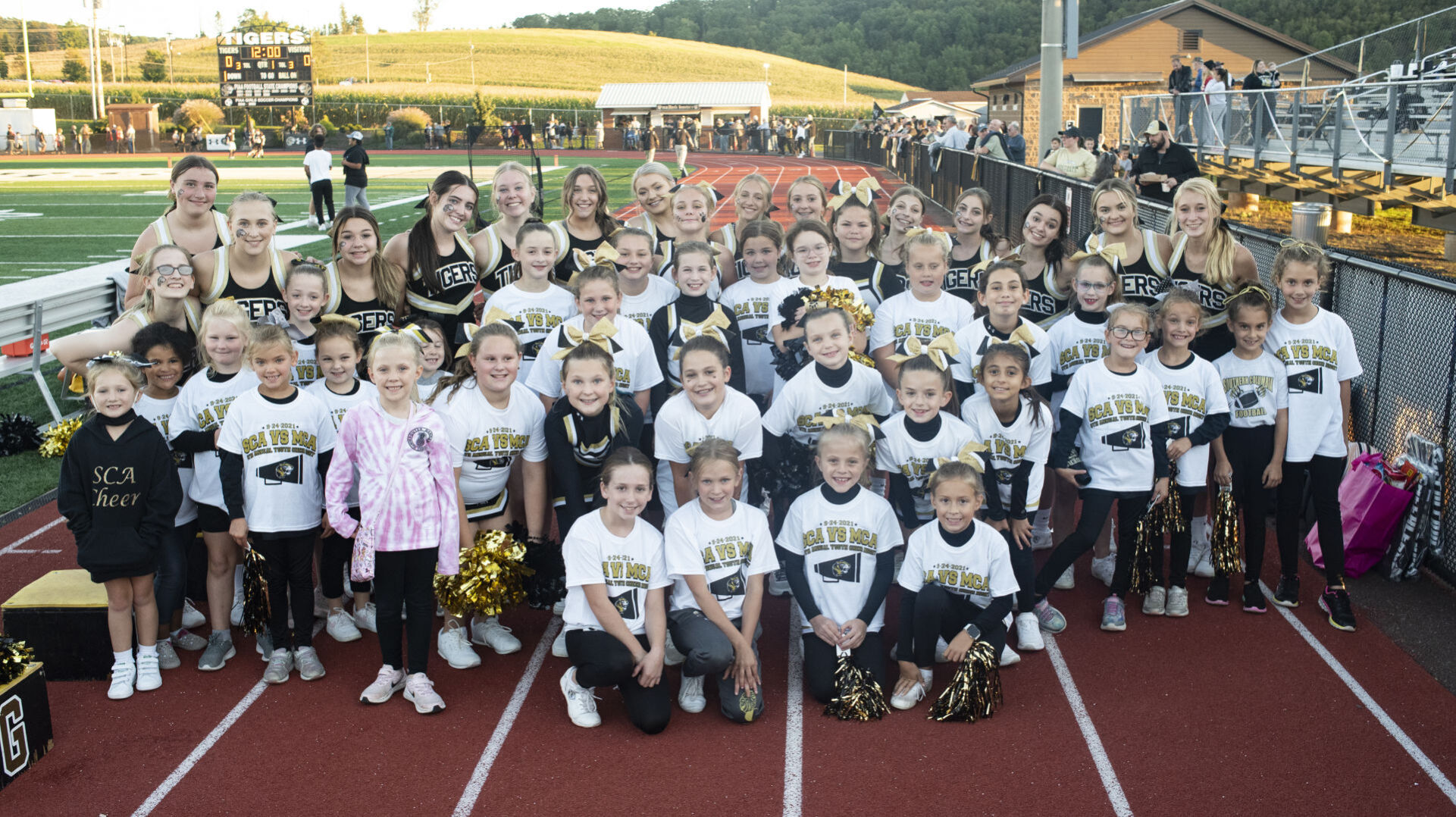 Youth cheerleaders join varsity squad